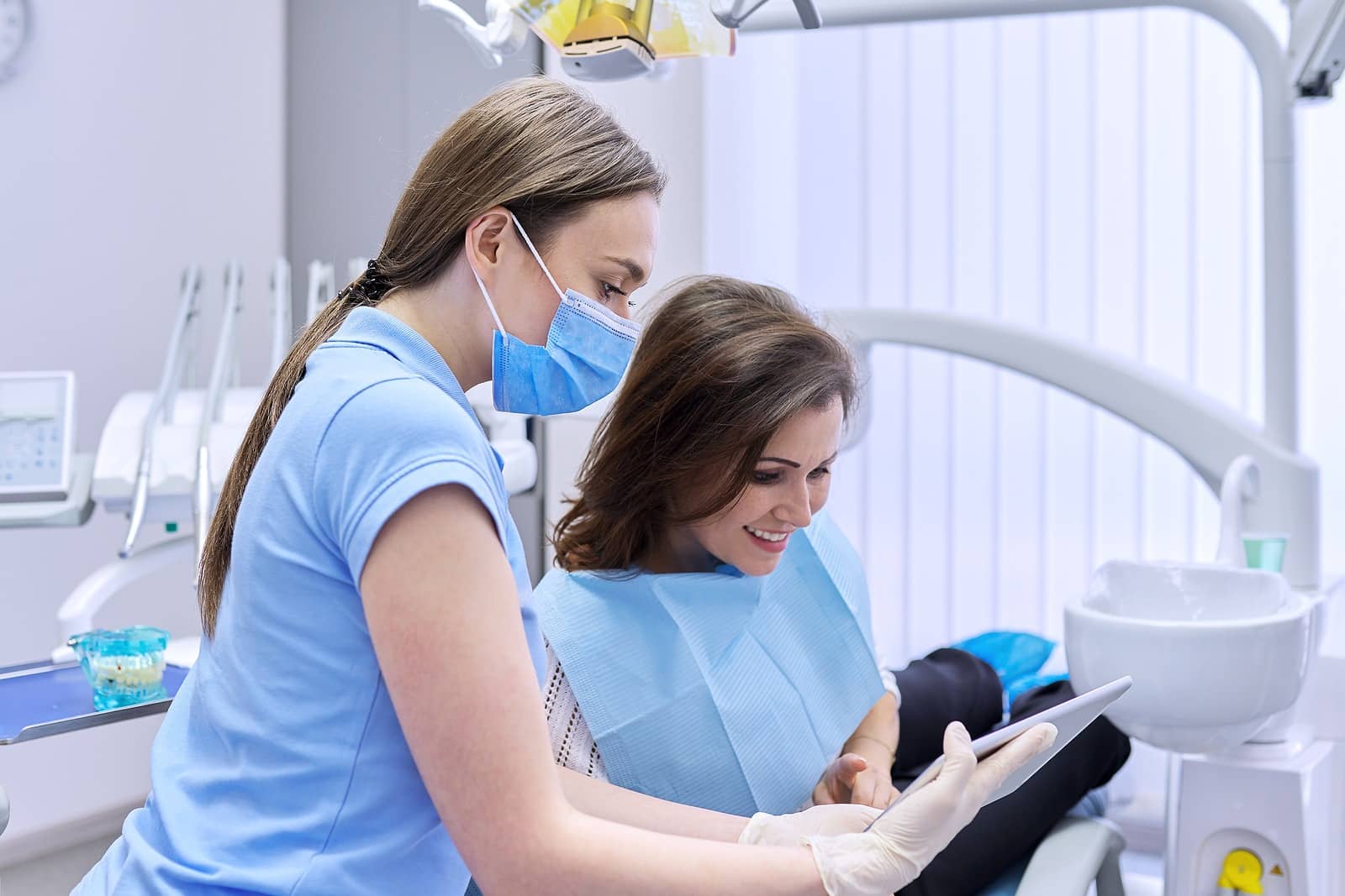 Dentist consulting with a patient in a treatment chair
